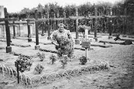 A Dutch woman cares for the graves of a Lancaster bomber crew of No. 460 Squadron RAAF, shot down when returning from a raid on Cologne, Germany, on 24 December 1944.